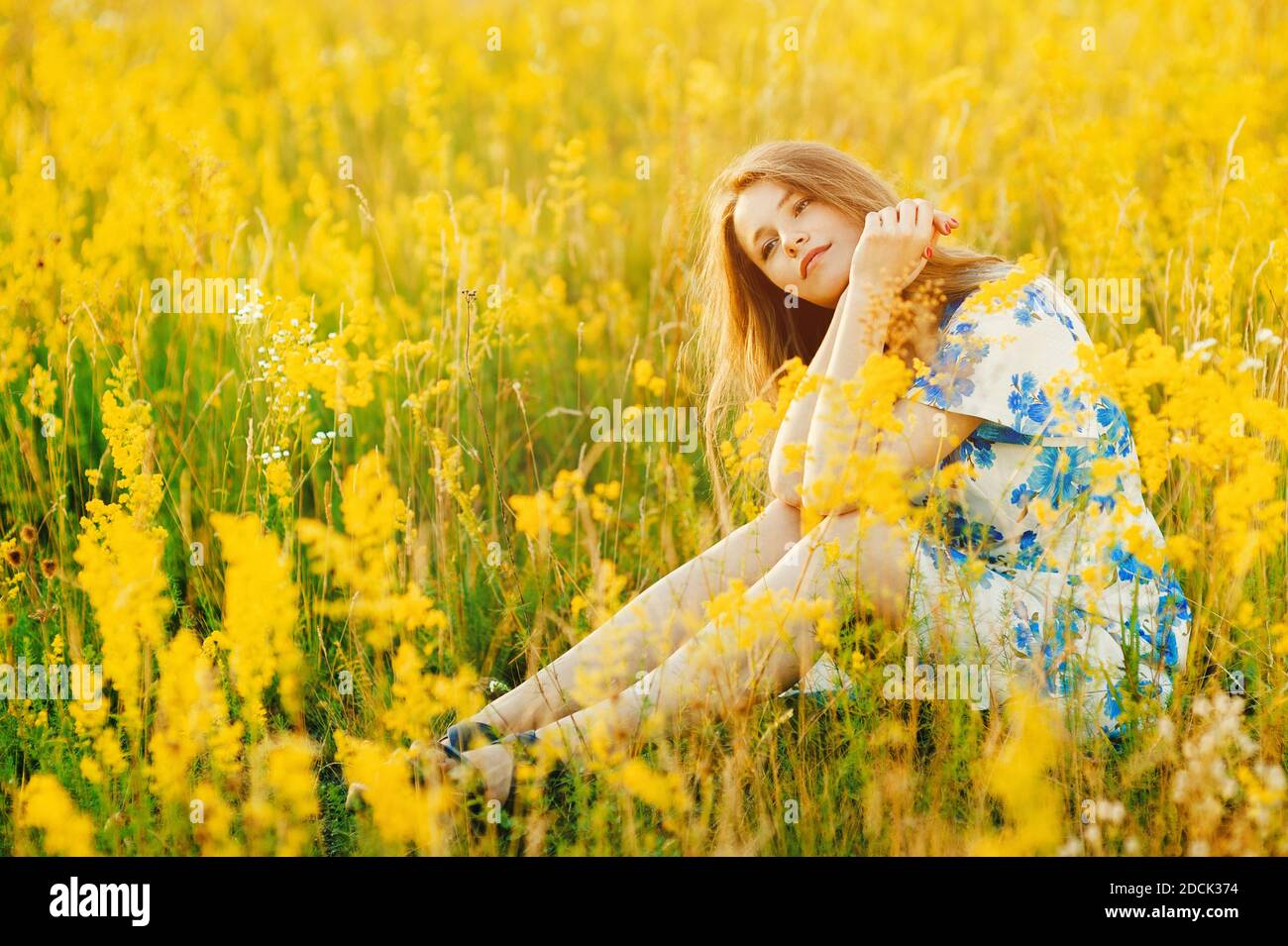 Beautiful cute girl on the flowers field Beautiful blonde woman in the ...