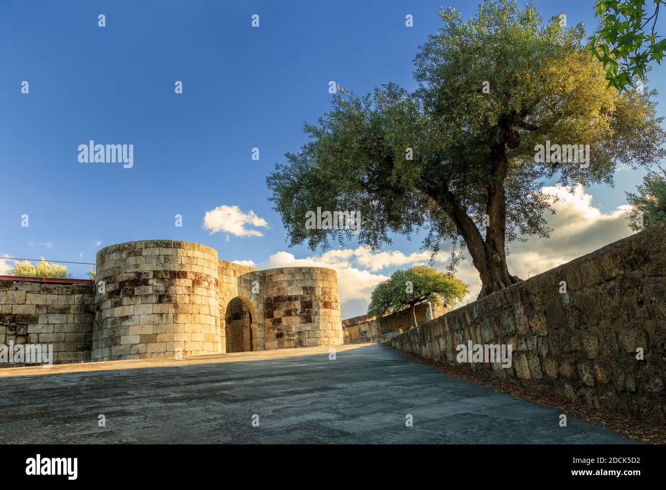 Main entrance to the wall of the historic village of Idanha-a-Velha in Portugal, lit by the late spring afternoon sun. Stock Photo