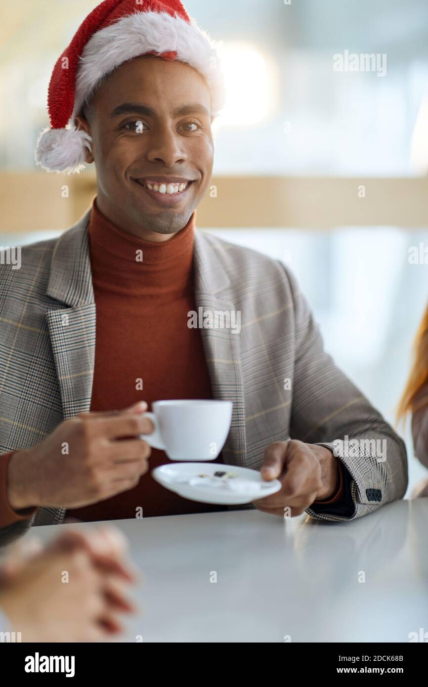 portrait of young afro-american businessman, drinking coffee, looking at camera. eye contact Stock Photo