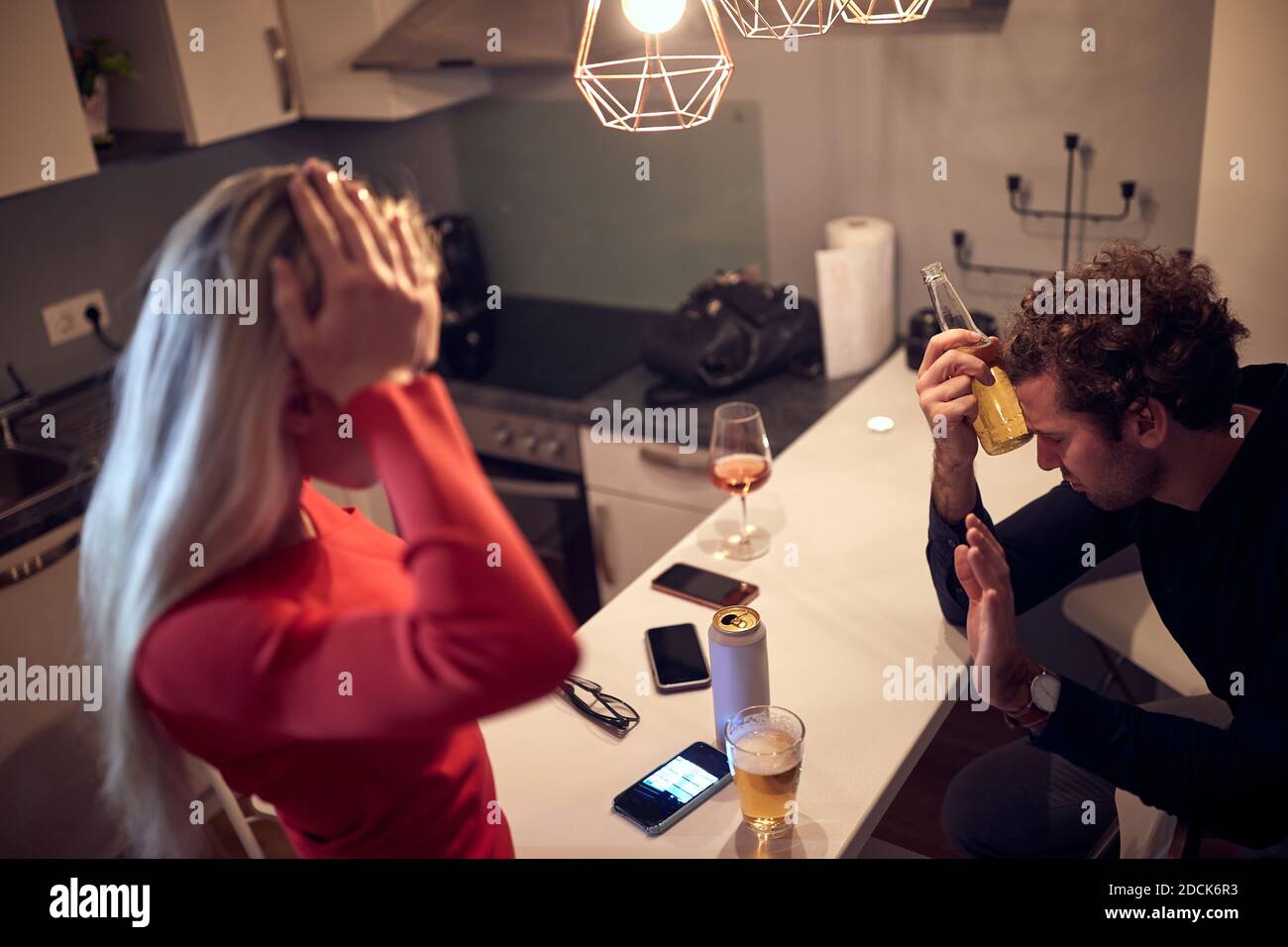 worried female trying to talk with drunk male. alcohol issue concept Stock Photo