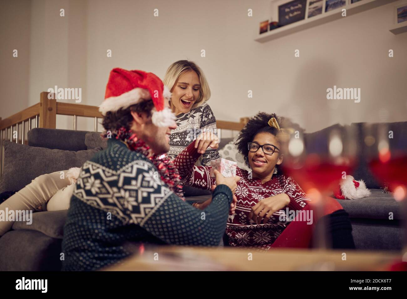 Group of friends celebrating New Year's Eve at home in relaxed atmosphere. Xmas, New Year, friends, celebration Stock Photo