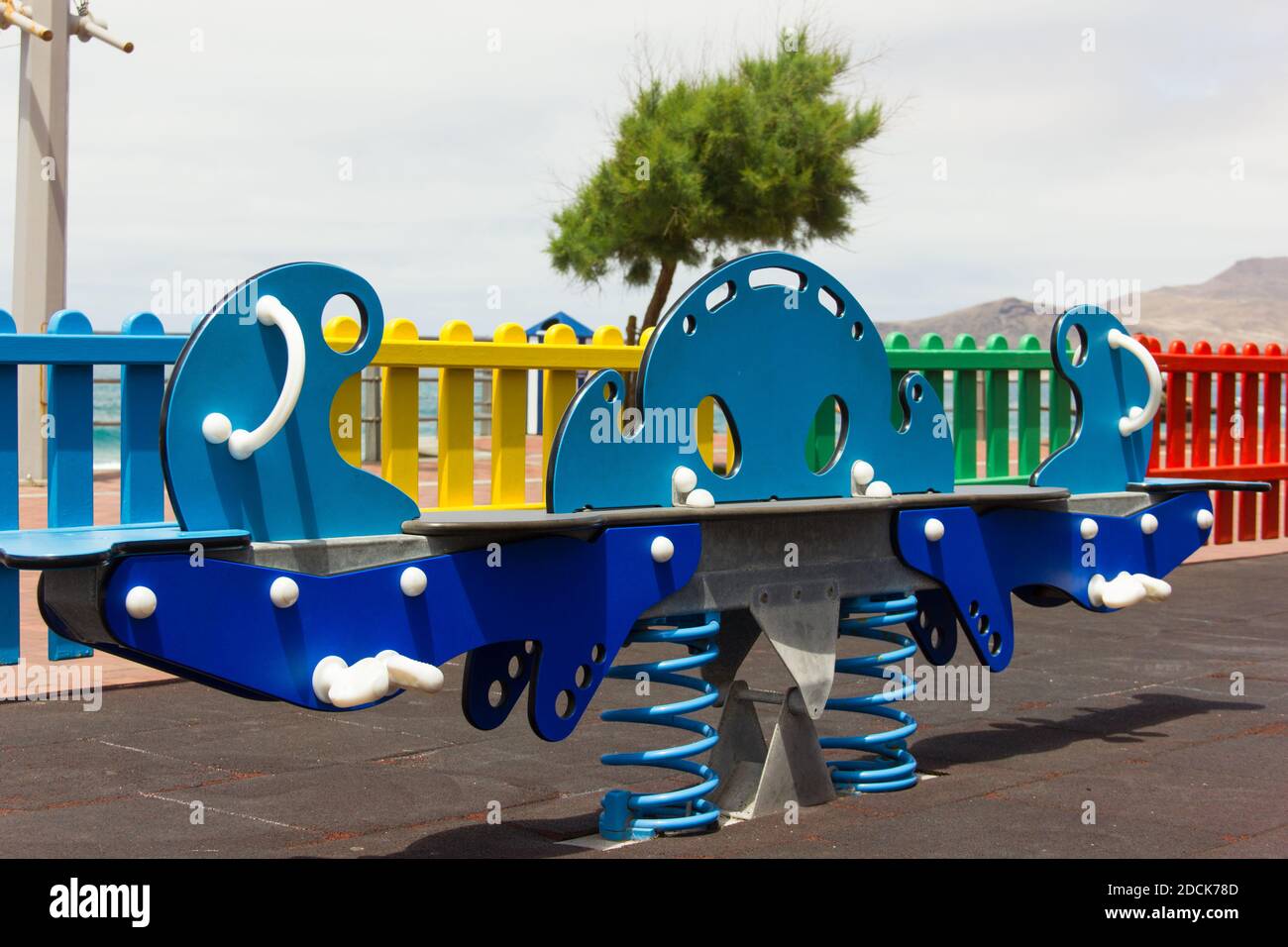 Colorful teeter totter on playground in Las Palmas city, Spain. Seesaw with two springs. Children fun zone concept Stock Photo
