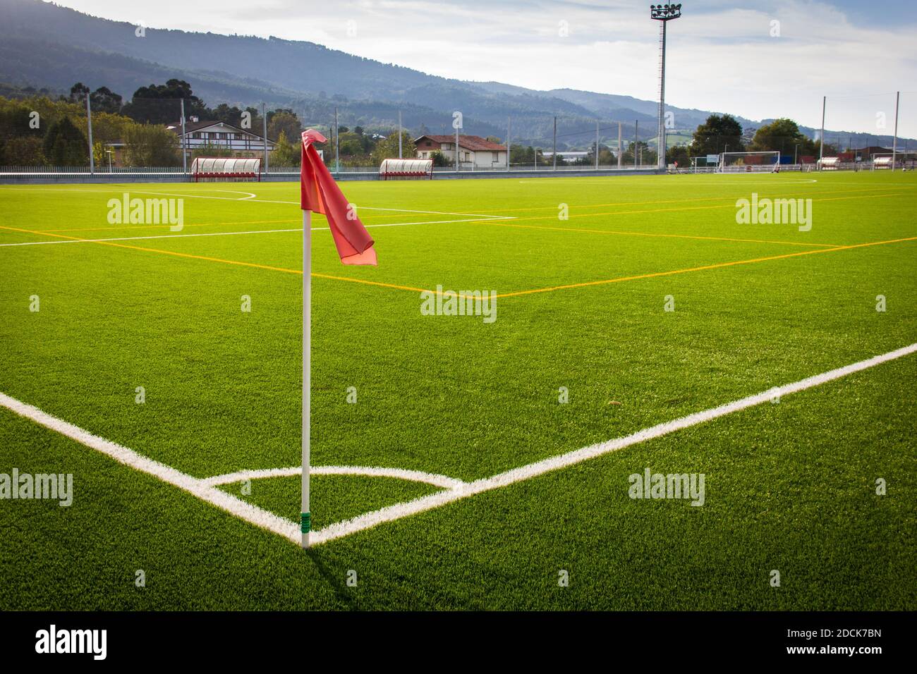 Red flag on corner kick in green artificial grass soccer field