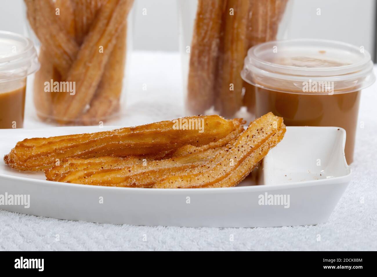Fried Churros sweets with sugar on white background Stock Photo