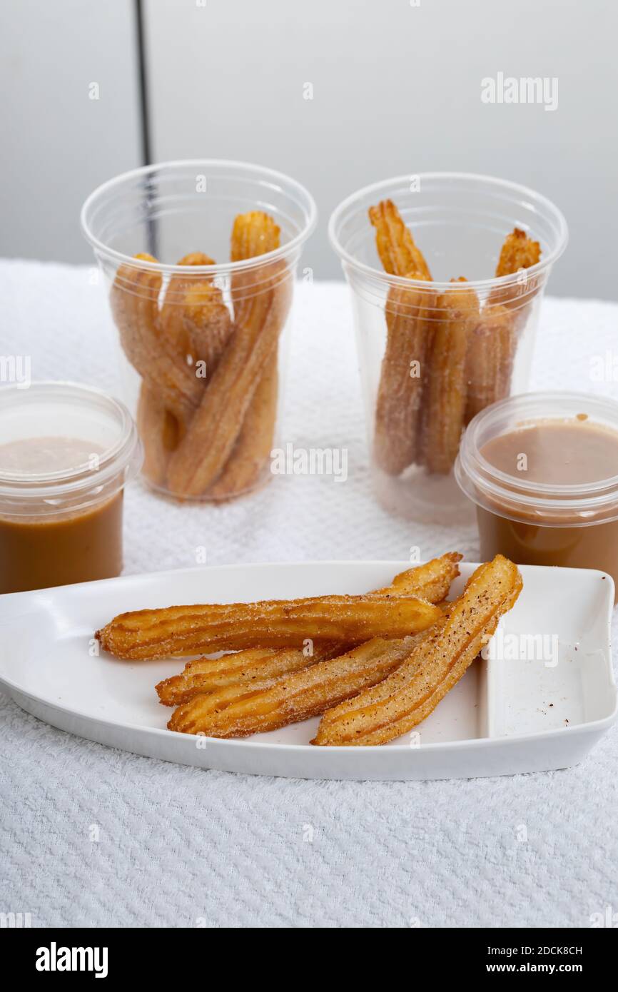 Fried Churros sweets with sugar on white background Stock Photo