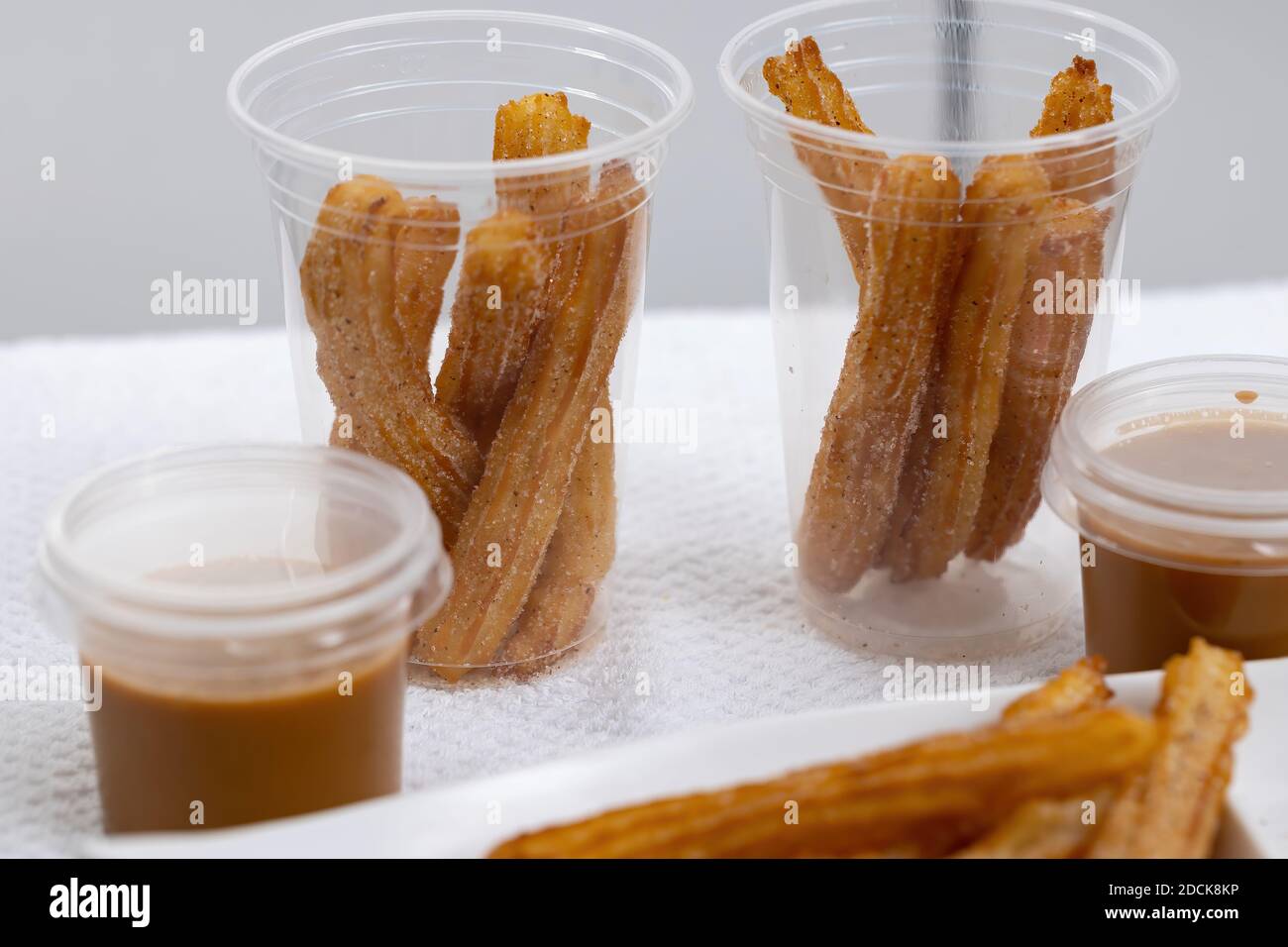 Fried Churros sweets with sugar on white background Stock Photo