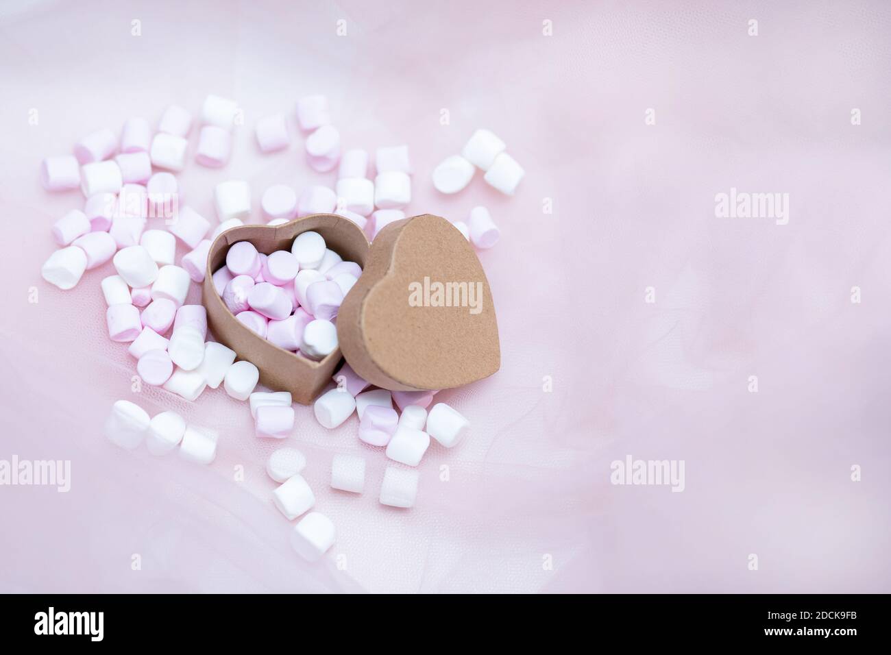 White and pink heart-shaped marshmallows are scattered from a cup 13730969  Stock Photo at Vecteezy