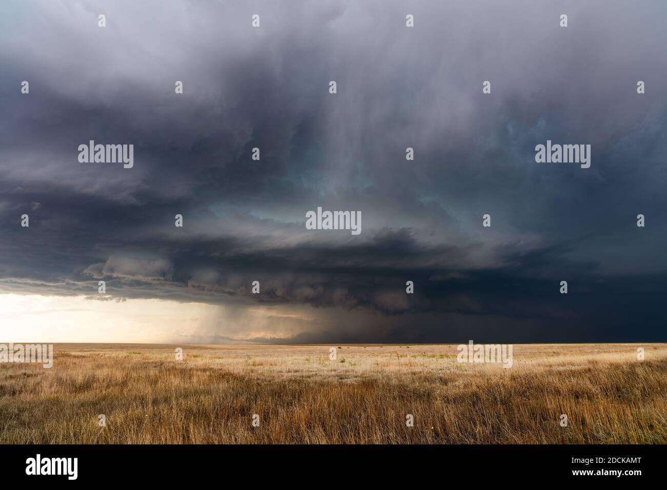 Stormy sky with dark storm clouds approaching over a field in Kansas Stock Photo