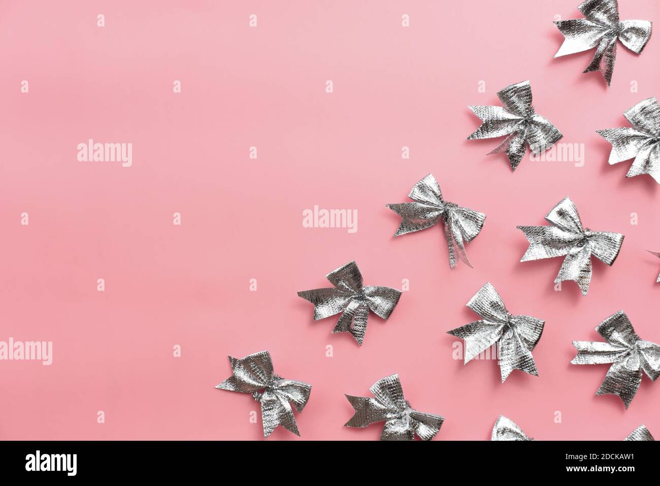 silver ribbon bows on pink background festive template for christmas silver ribbon bows on pink background festive template for christmas