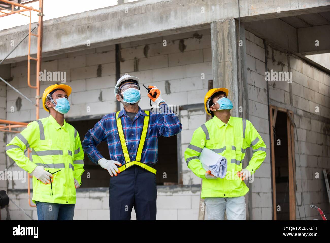 Asian team construction worker control in the house structure at construction site Stock Photo