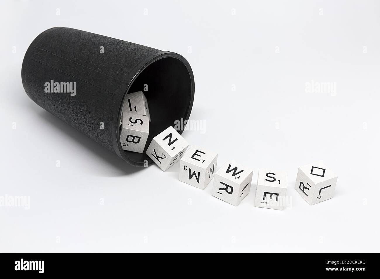 Dice cup with dice with letters and rhombus as joker, lettering News, symbolic image for news, news, Germany Stock Photo