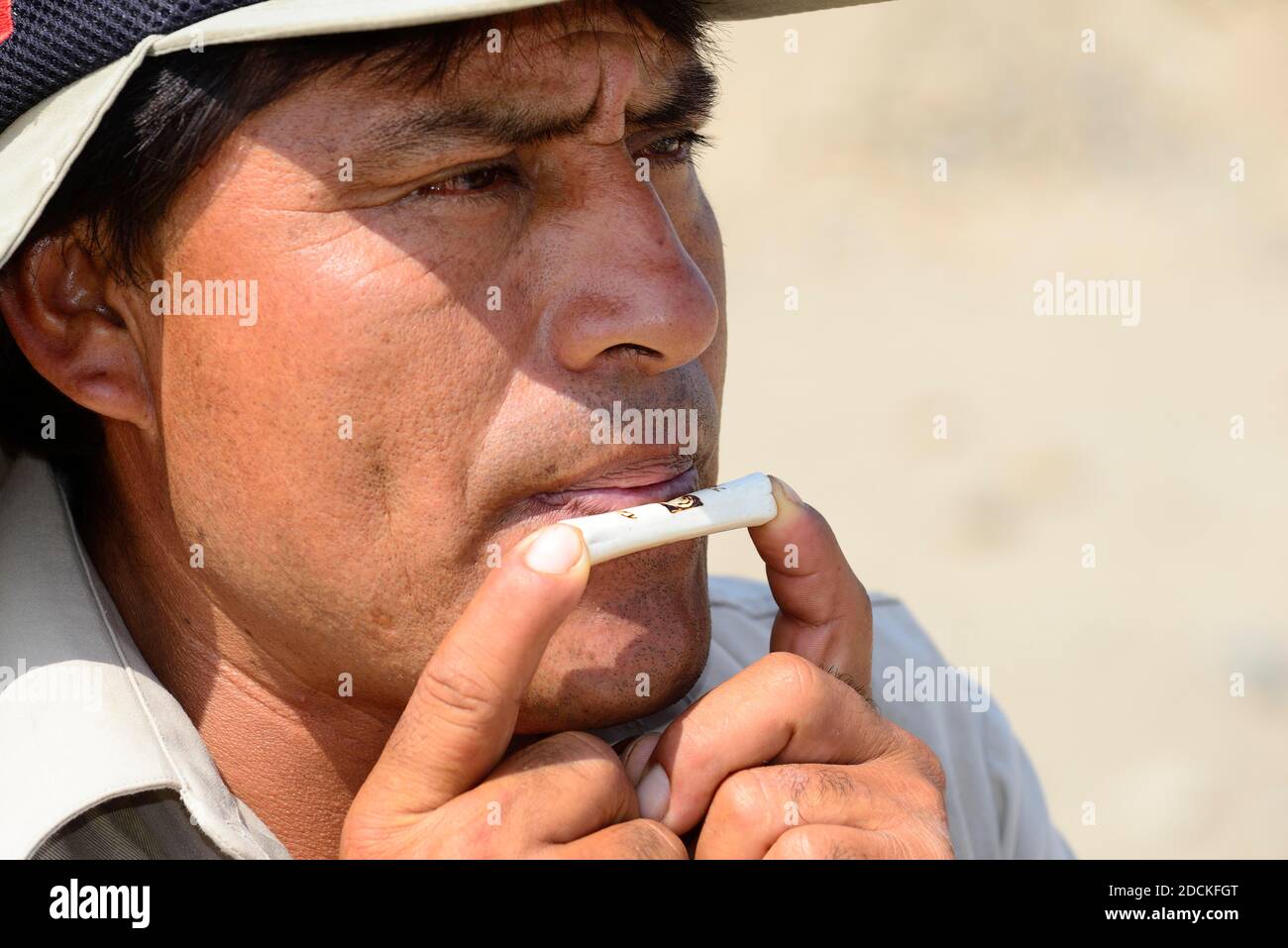 Indigenous man plays on a bone flute, Caral, Valley of the Rio Supe, Peru Stock Photo