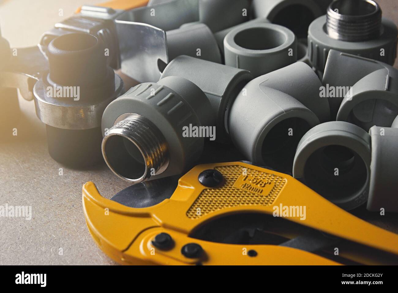 Closeup plastic fittings, soldering iron and scissors for