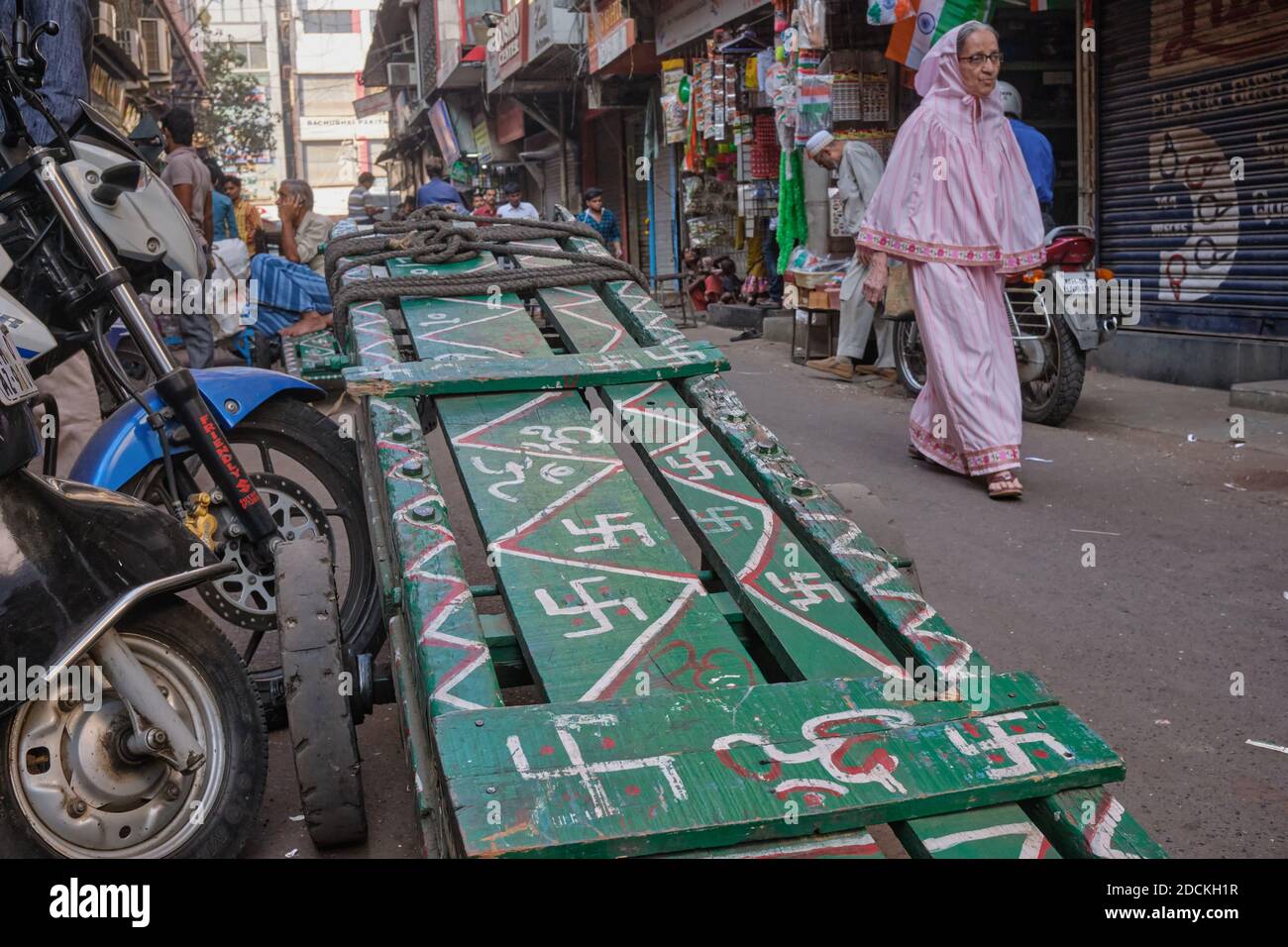 The hand cart of a porter in Mumbai, India, decorated with swastikas, the Hindu symbol of good luck (bottom of the pic: the sacred Aum / OM symbol Stock Photo