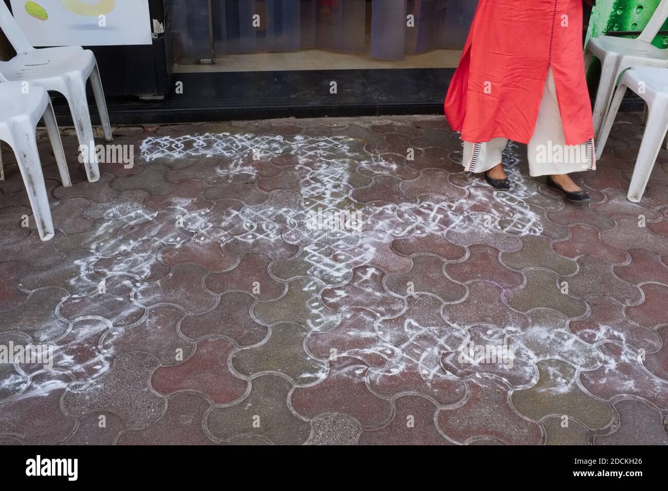A swastika, a Hindu symbol for good fortune or blessing drawn in chalk in front of a restaurant in Mumbai, India Stock Photo