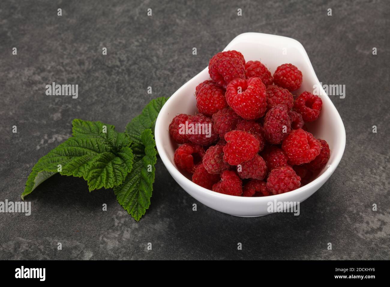 Red bright ripe sweet raspberry with leaf Stock Photo - Alamy