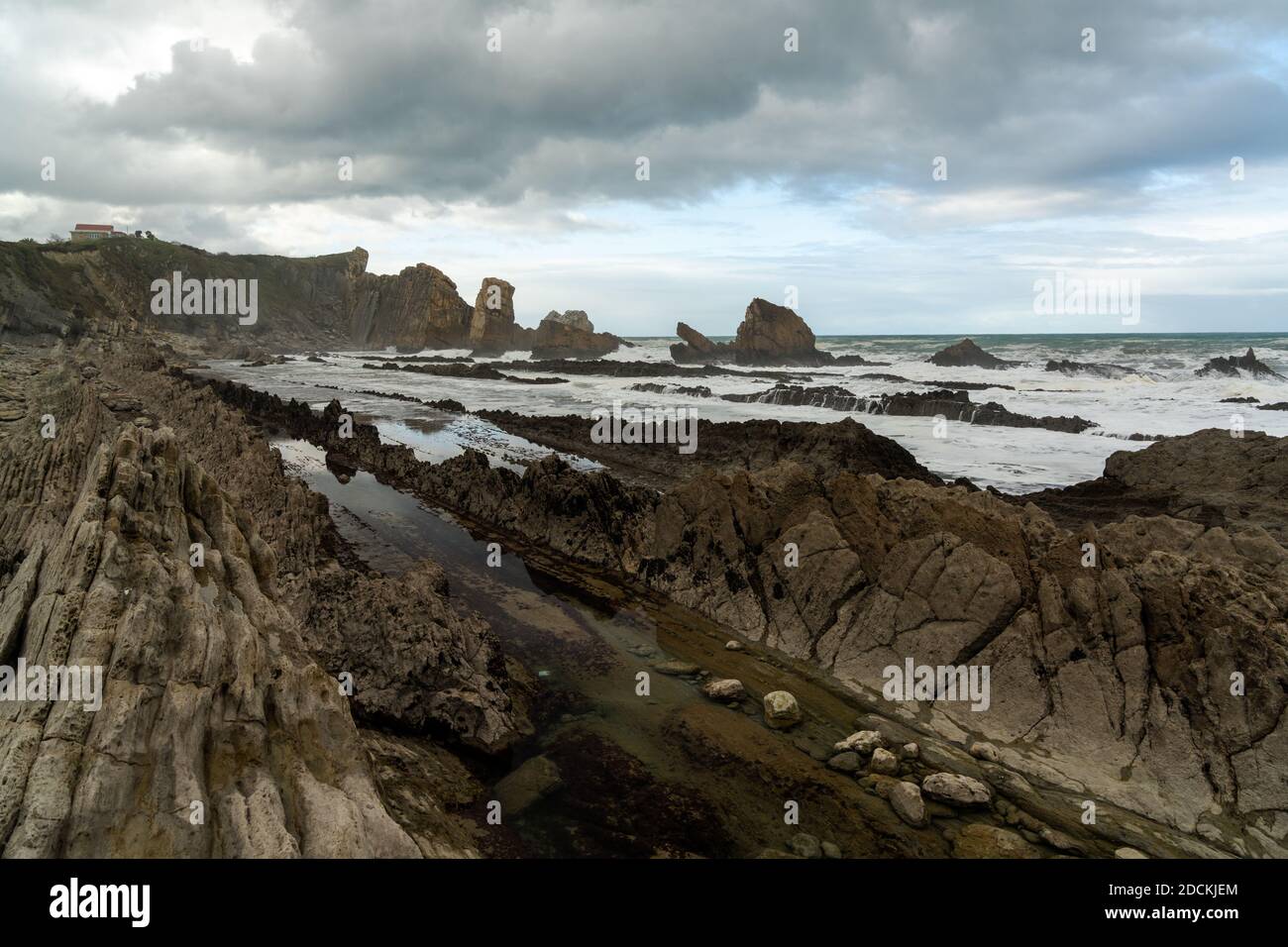 A rocky and wild coast with stormy waves hitting the shore Stock Photo ...