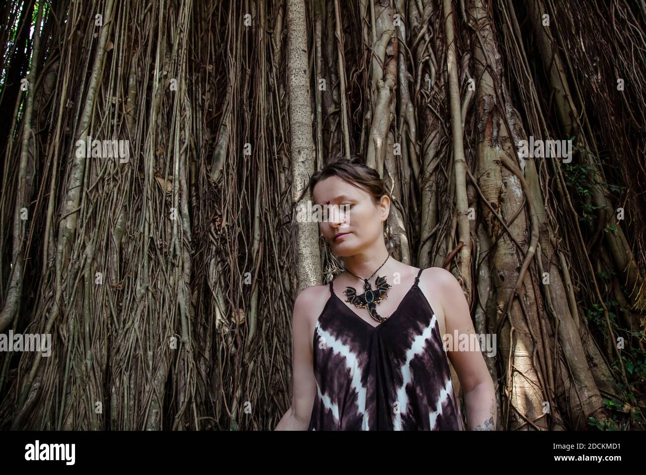 Portrait of woman in front of Bodhi tree Stock Photo