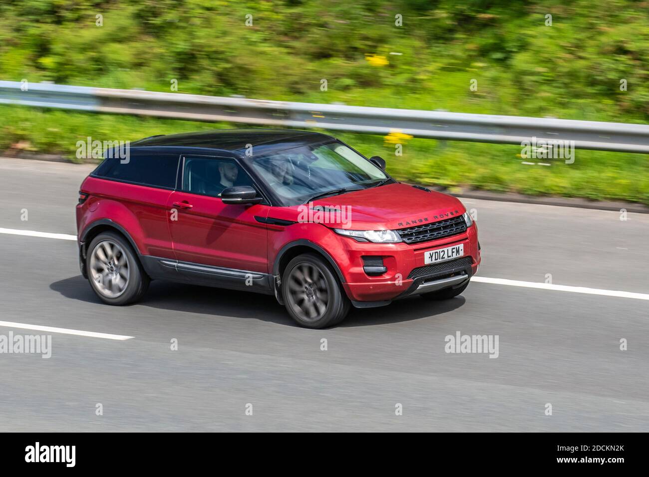 2012 Red Land Rover Range Rover Evoque Pur Tec; Vehicular traffic, moving vehicles, cars, vehicle driving on UK roads, motors, motoring on the M6 motorway highway UK road network. Stock Photo