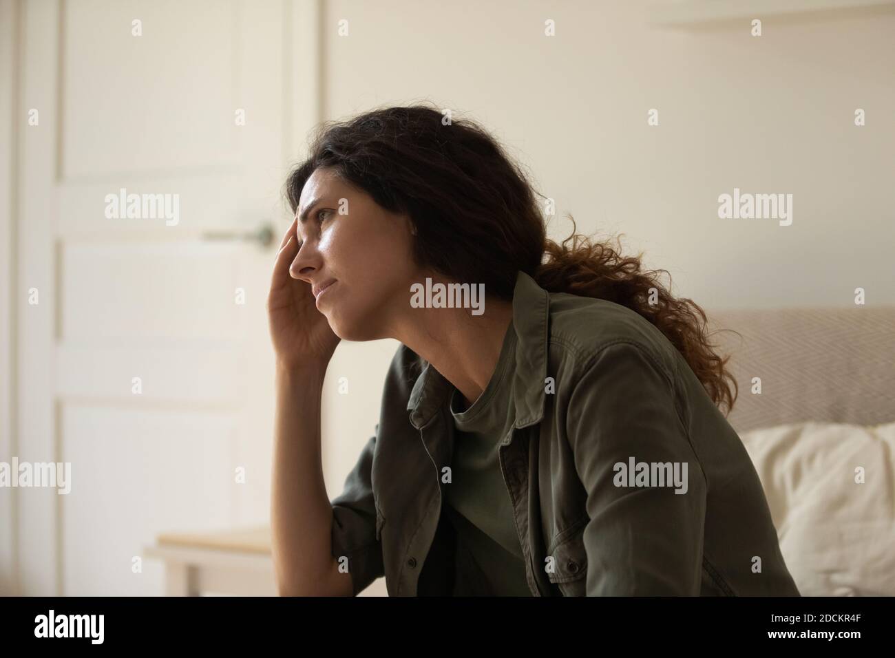 Upset young woman feeling unhappy stressed at home Stock Photo