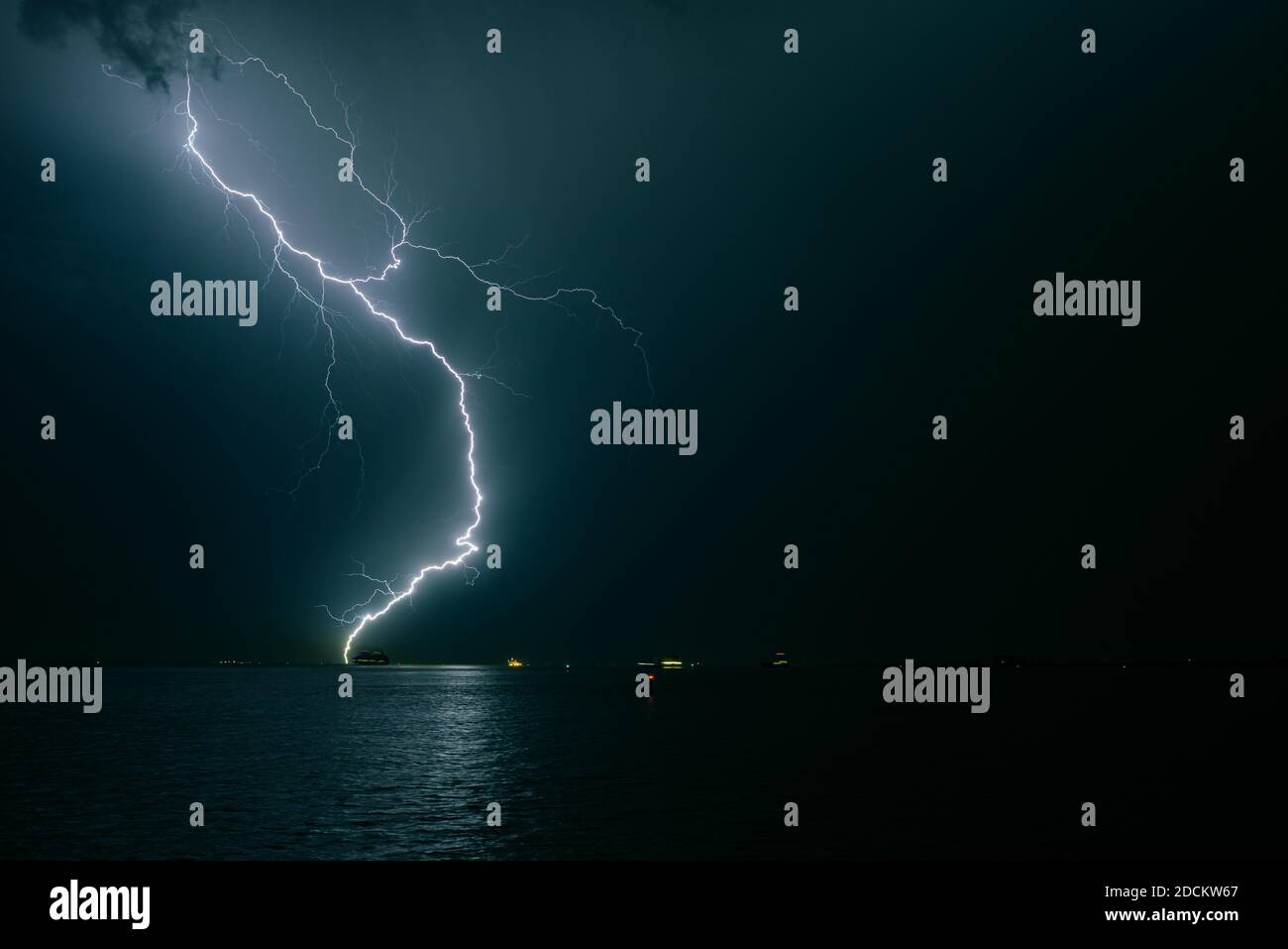 Lightning bolt strikes in the water of the sea Stock Photo Alamy