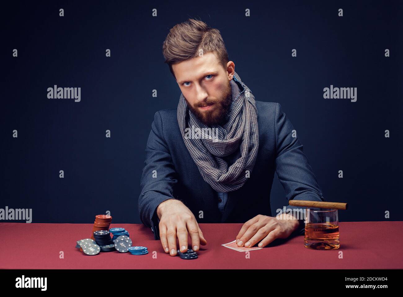 Premium Photo  Stylish bearded man in suit and scarf playing in dark casino