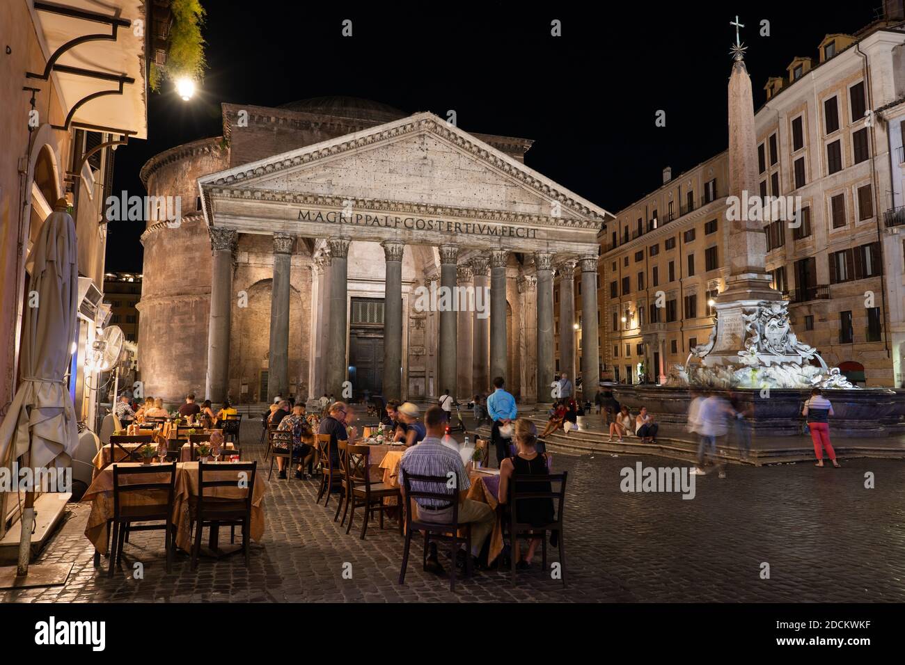 City of Rome at night in Italy, the Pantheon ancient Roman temple as seen from Piazza della Rotonda square with cafe tables, fountain and ancient Egyp Stock Photo