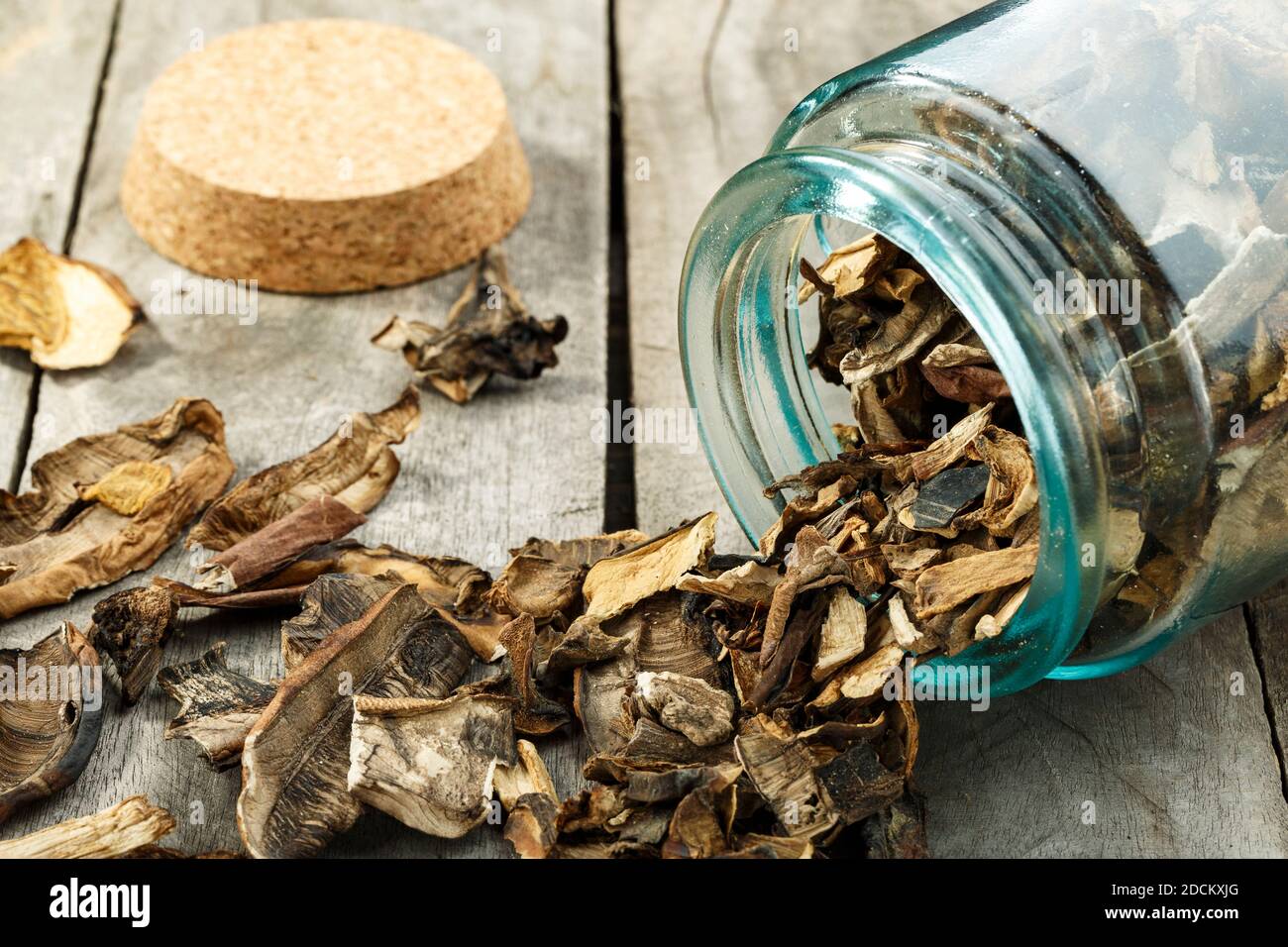 Dried mushrooms in a glass jar on a wooden table. Space for text ...