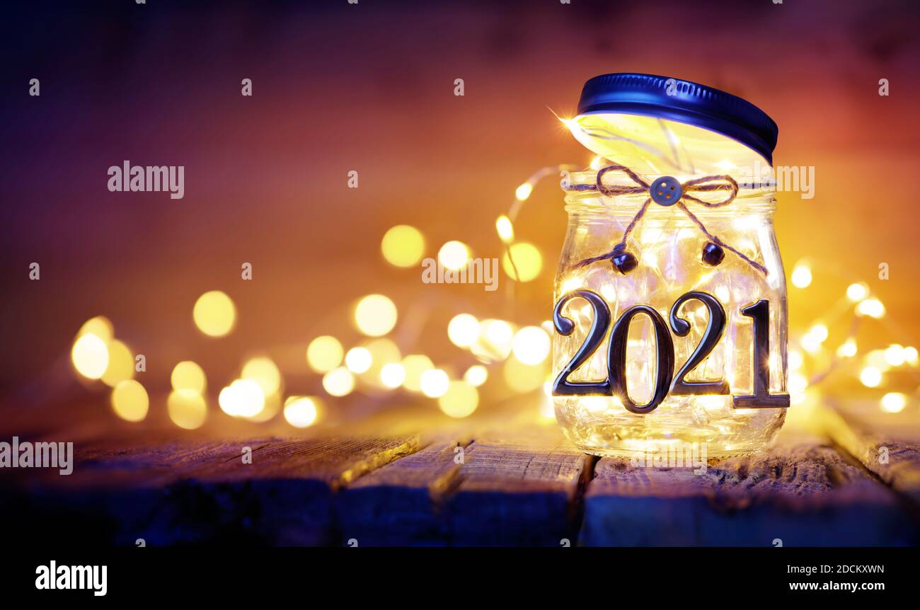 Open 2021 - Christmas Lights In The Jar With Golden Numbers - Defocused Background Stock Photo