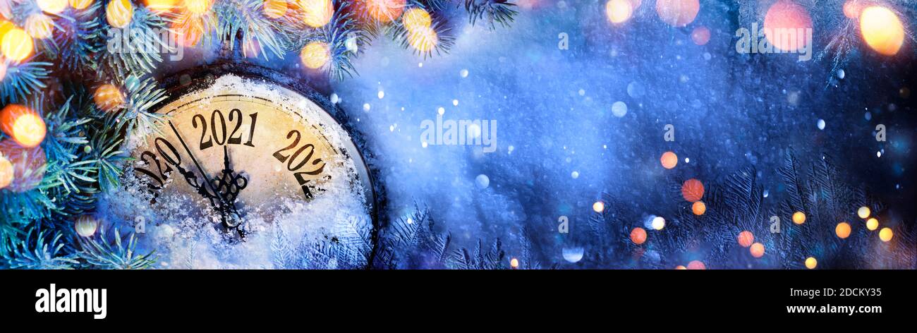 Happy New Year 2021 - Countdown To Midnight - Clock And Fir Branches On Snow Stock Photo