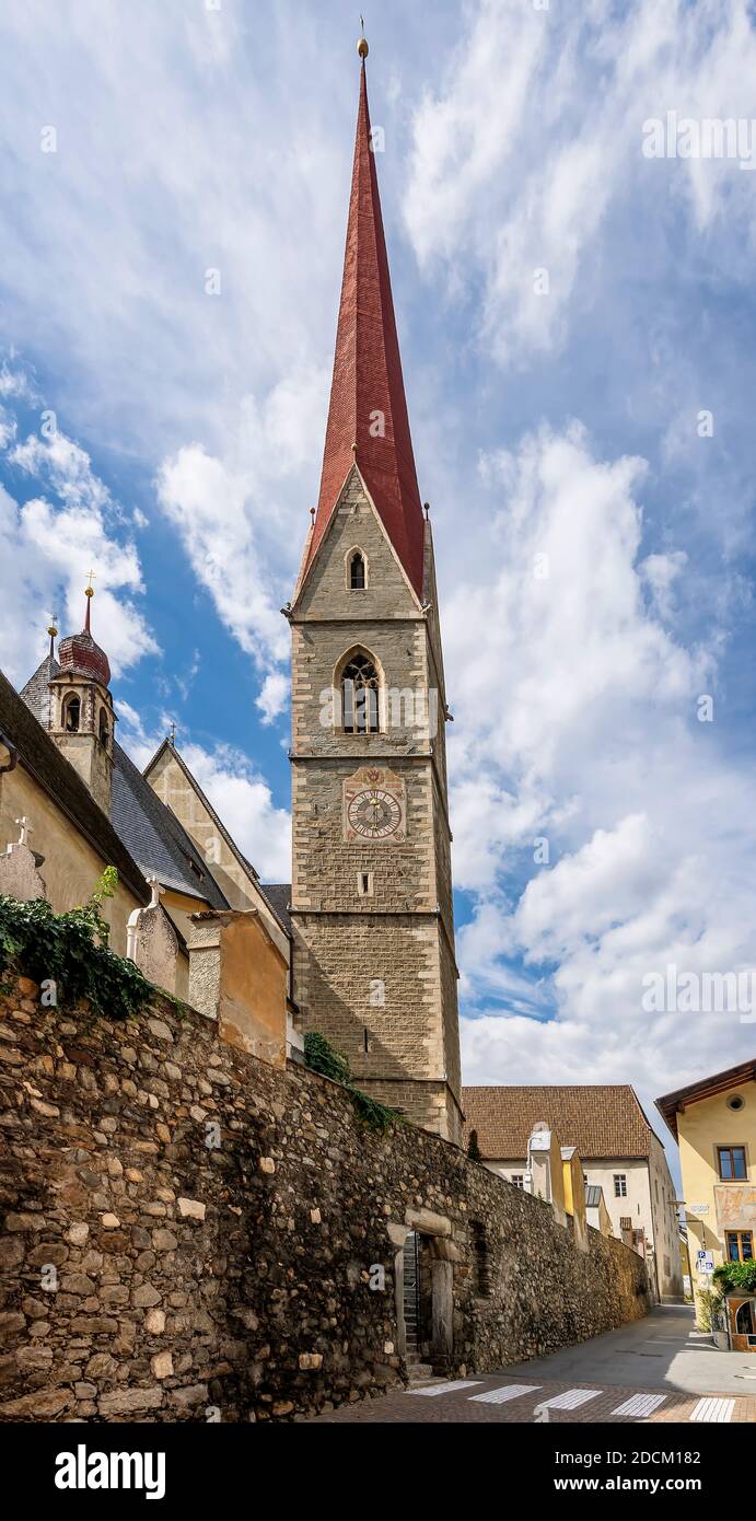 The high bell tower of the parish church of Santa Maria Assunta (in German Pfarrkirche Mariä Himmelfahrt) in Silandro, South Tyrol, Italy Stock Photo