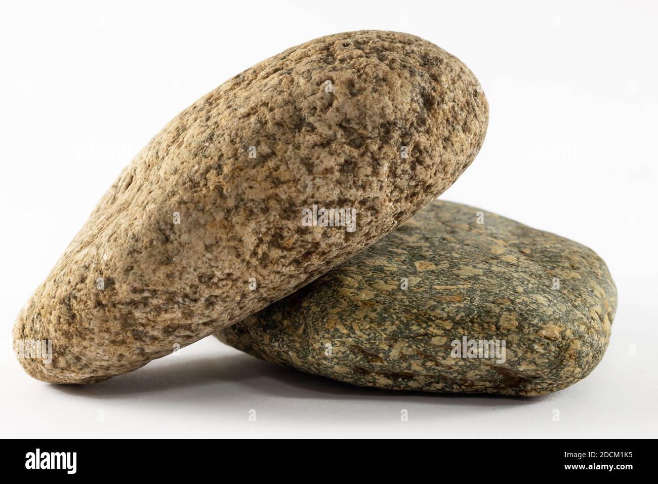 Two stones isolated on white background. Rough texture, close up, zen concept. Stock Photo