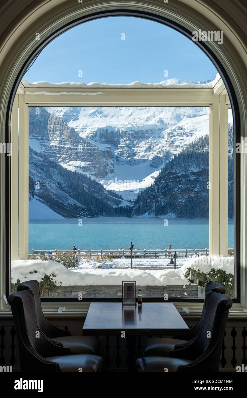 Fairmont Chateau Lake Louise in early winter sunny day morning. Mist ...