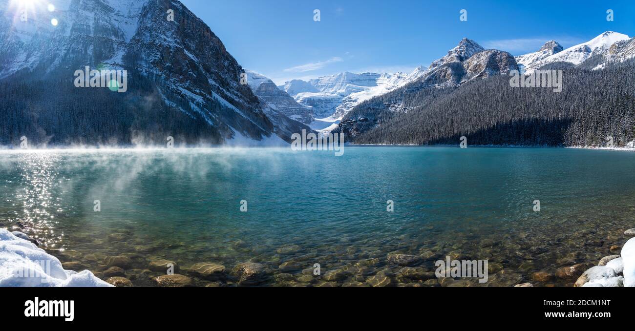 Lake Louise in early winter sunny day morning. Mist floating on ...
