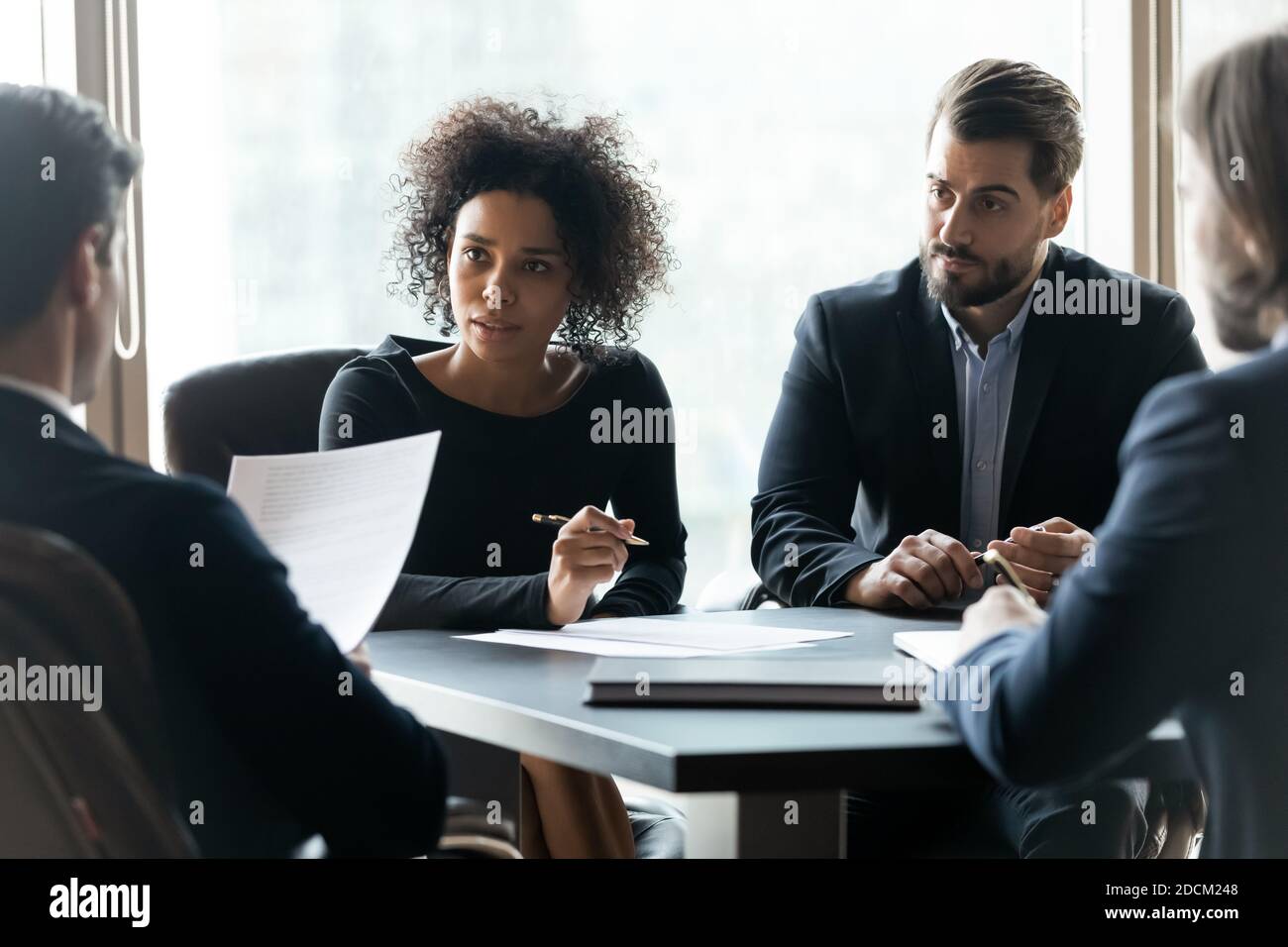Multiracial businesspeople brainstorm at team office meeting Stock Photo