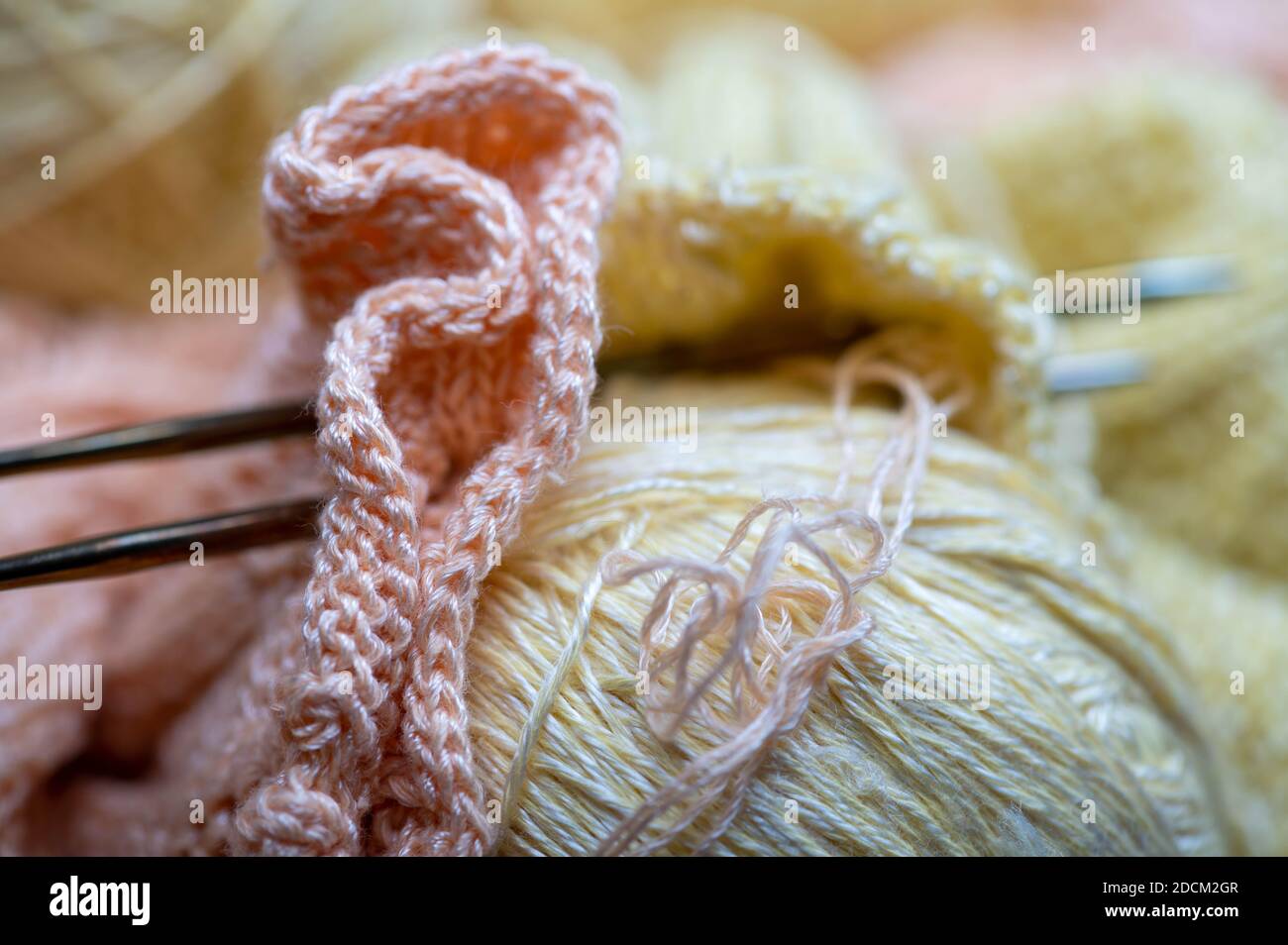 Knitting needles, skeins of yarn and knitted fabric, home needlework ...