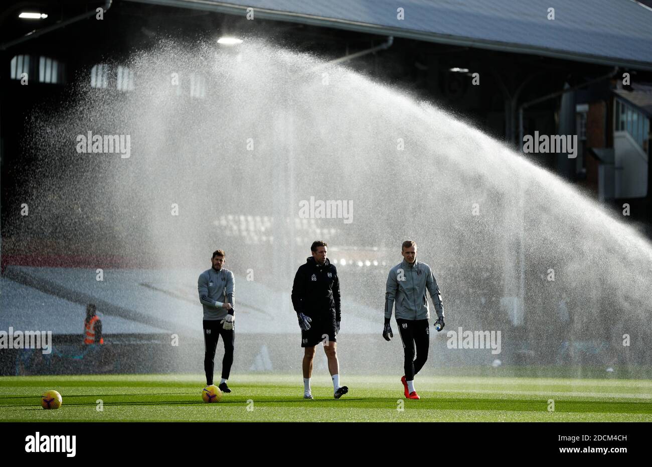 Fulham goalkeepers Fabri (left) and Marek Rodak (right) come out to warm up alongside goalkeeping coach Rob Burch before the Premier League match at Craven Cottage, London. Stock Photo