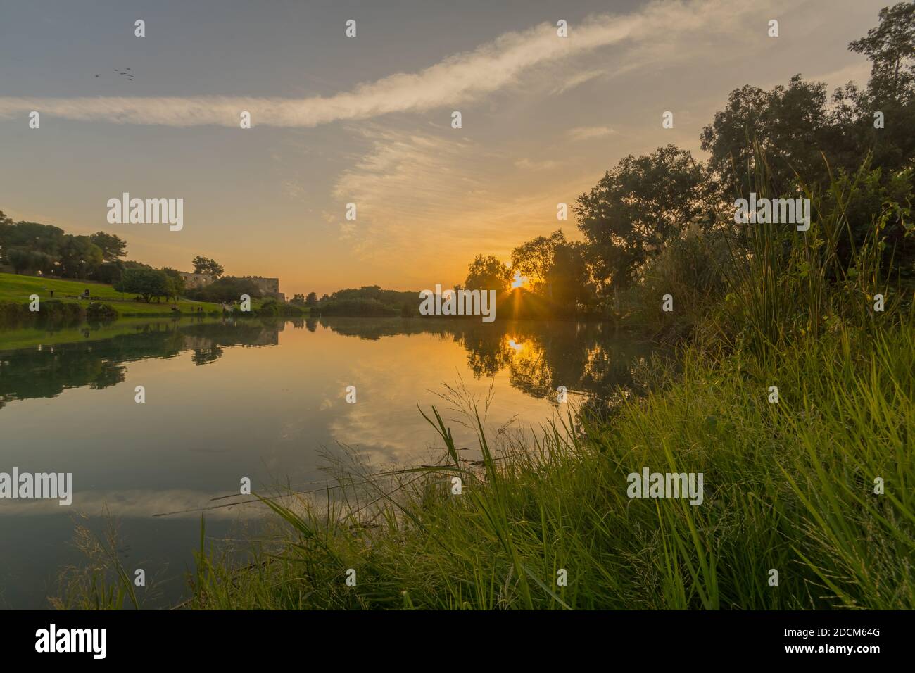 Sunset view of the lake, with the Antipatris Fort (Binar Bashi), in Yarkon (Tel Afek) National Park, central Israel Stock Photo