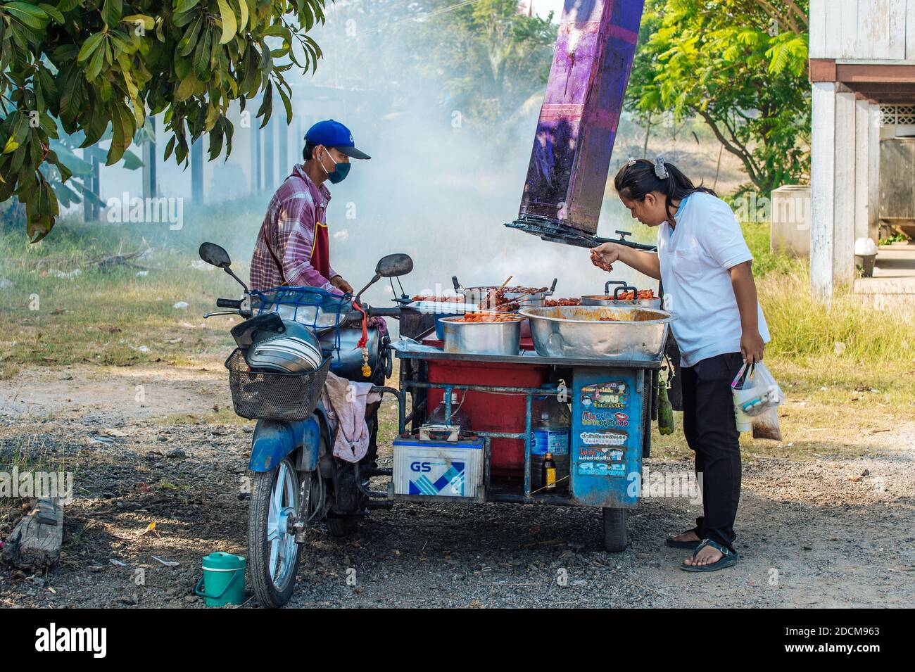 Vendor selling grilled chicken at a local market in Khao Tao village just south of Hua Hin in Thailand Stock Photo