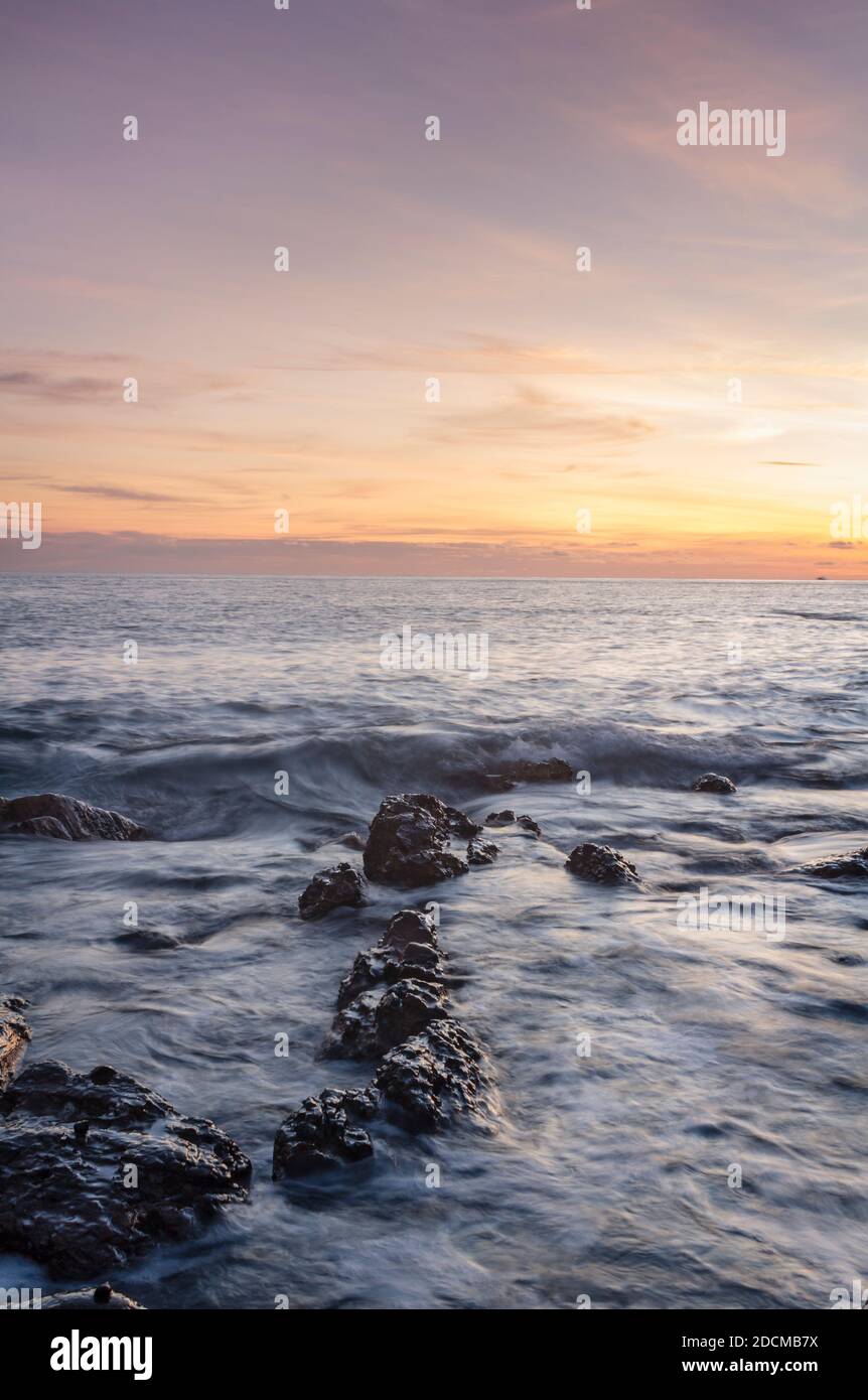 Seeing golden light on the horizon during sunsetting. Stock Photo