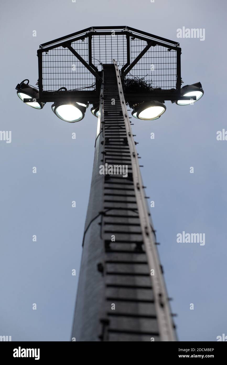 Looking up at lit floodlight from below at sport / soccer / football stadium Stock Photo