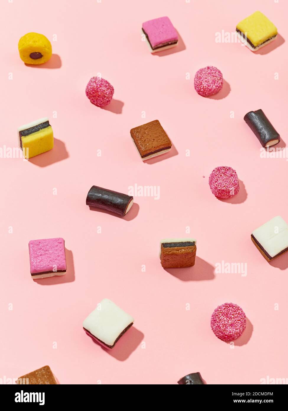various licorice candies pattern on pink background, selective focus Stock Photo