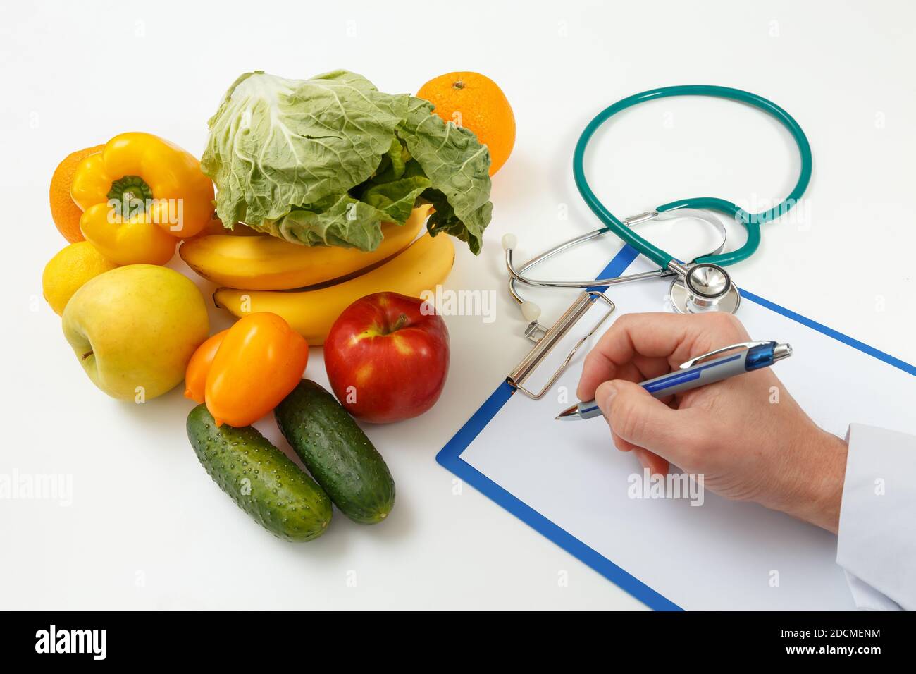 Nutritionist doctor writing diet plan on table. Right nutrition and slimming concept Stock Photo