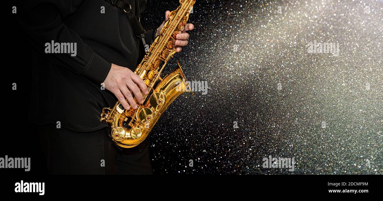 Saxophone Player hands Saxophonist playing jazz music. Alto sax musical instrument closeup on
