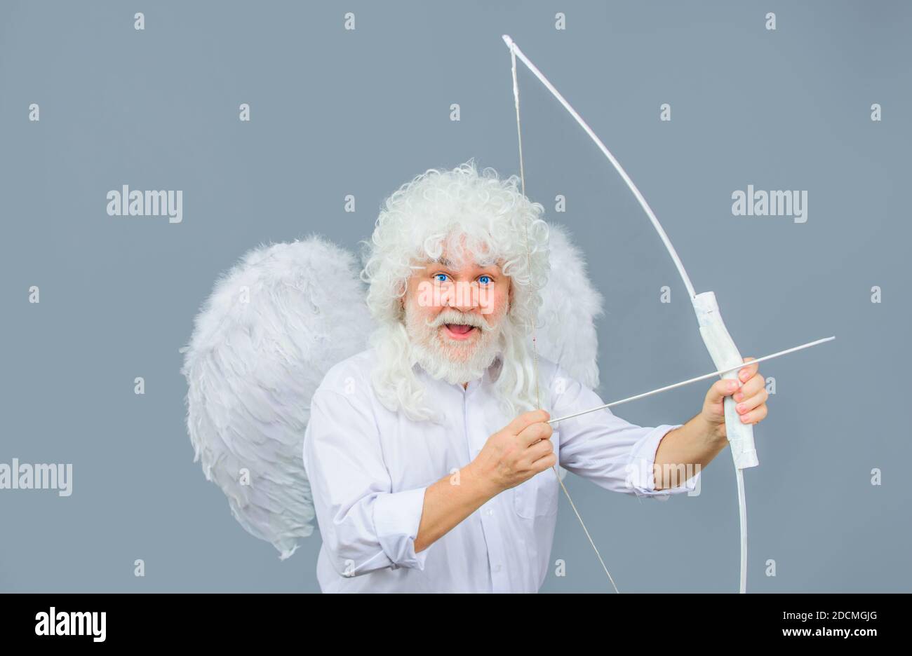 Arrow of love. Cupid throws arrow with bow. Bearded angel with bow and arrow. Cupid in valentine day. Valentines Day concept. Valentines Day Stock Photo