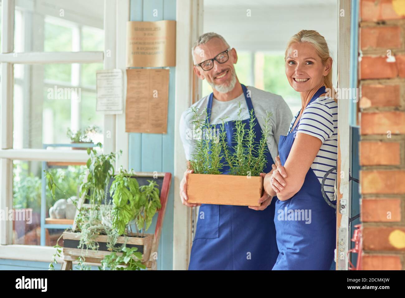 Middle aged couple standing in doorlet of garden house Stock Photo - Alamy