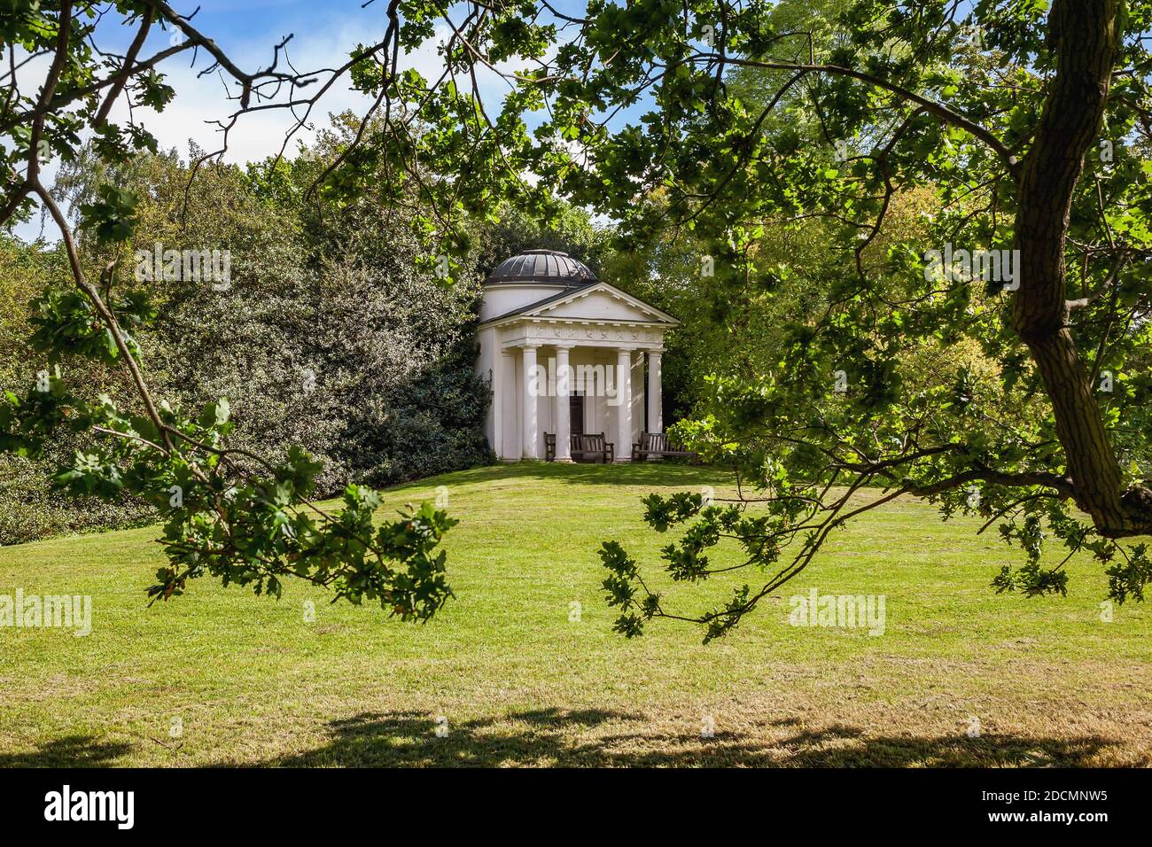 Looking through an opening in the trees at the Temple of Bellona Built by Sir William Chambers in 1760, taken at Kew Gardens Richmond 19th of May 2015 Stock Photo