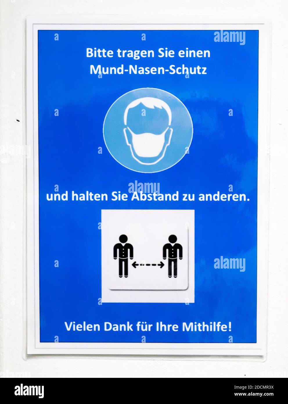 German sign during corona virus telling to wear a face mask for protection during the 2020/2021 corona pandemic Stock Photo