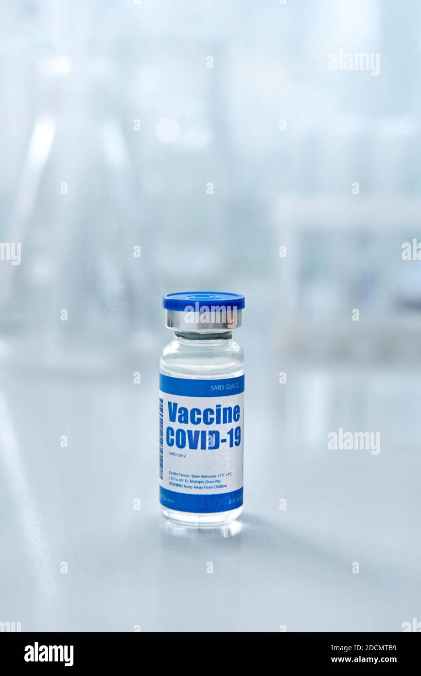 Covid 19 coronavirus vaccine vial bottle for injections on medical background. Stock Photo