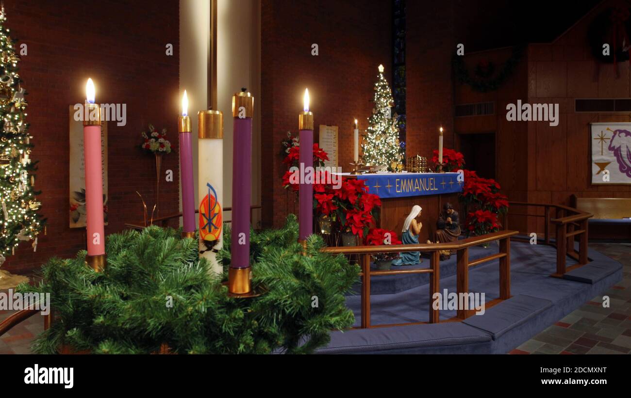 Advent wreath in church chancel with three candles lit Advent Third
